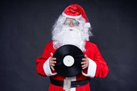 Santa Claus Holding a Vinyl Record